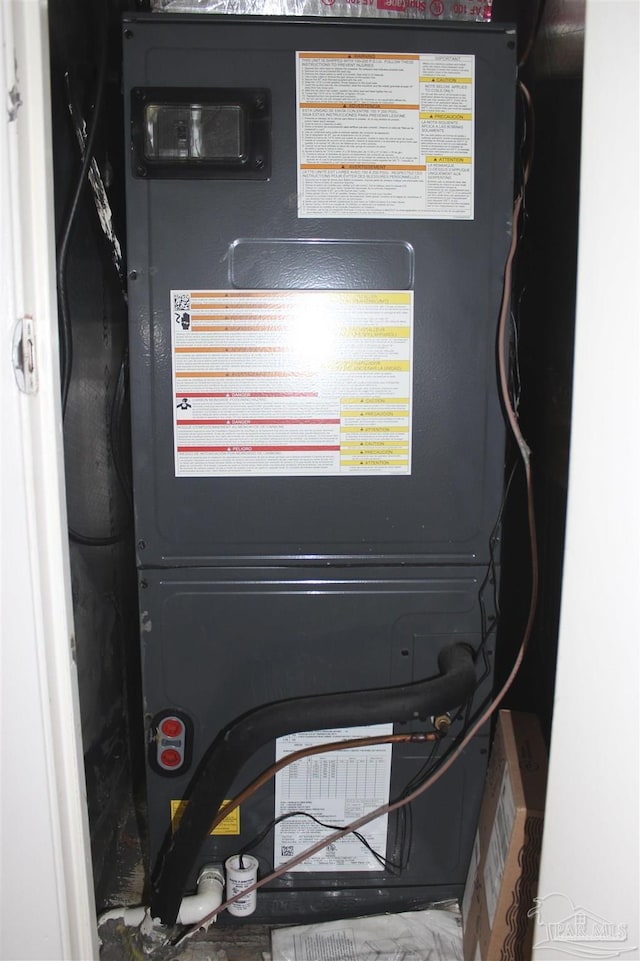 utility room featuring heating unit