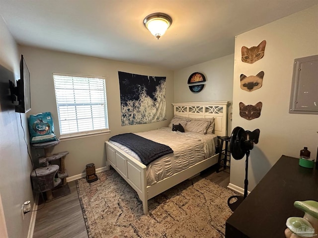 bedroom with wood-type flooring and electric panel