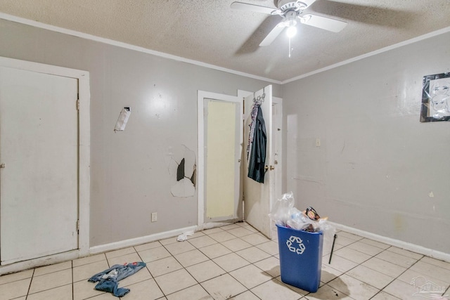 spare room featuring light tile patterned flooring, a textured ceiling, and ornamental molding