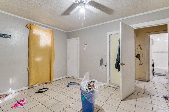 exercise area with light tile patterned floors, a textured ceiling, ceiling fan, and ornamental molding