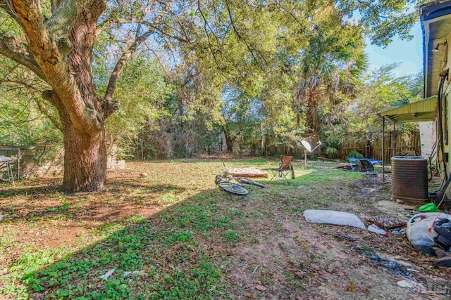 view of yard featuring cooling unit and fence