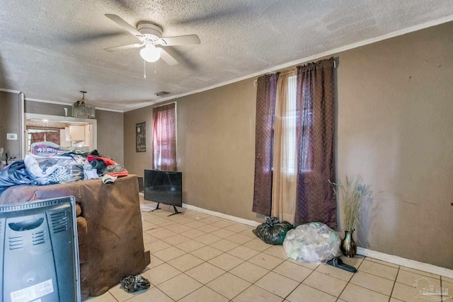 living room featuring light tile patterned floors, a textured ceiling, crown molding, and a ceiling fan