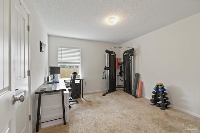 home office with a textured ceiling and light carpet