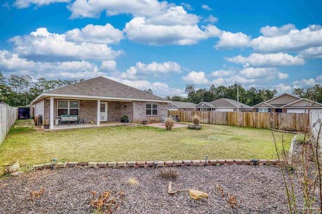 back of property featuring a patio and a yard