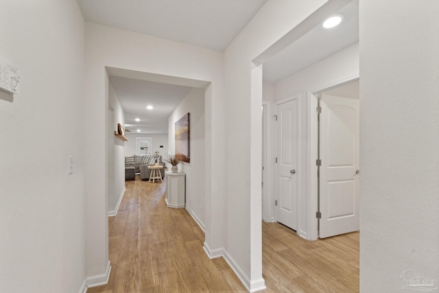 corridor with light hardwood / wood-style flooring