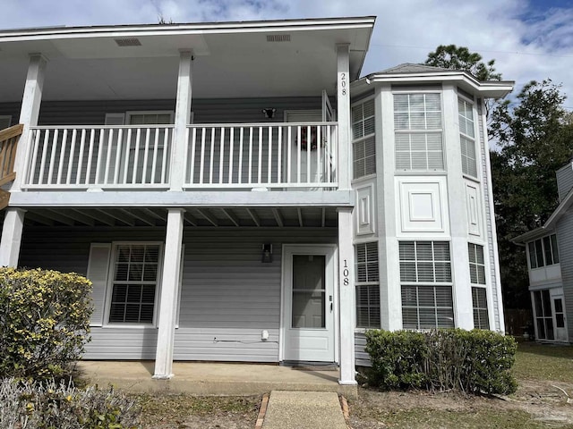 view of front of home featuring a porch and a balcony