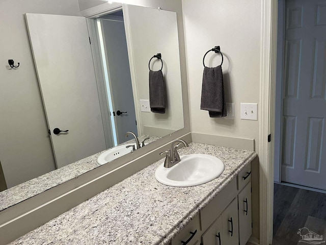 bathroom with vanity and wood finished floors