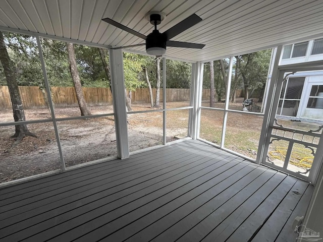 unfurnished sunroom featuring ceiling fan