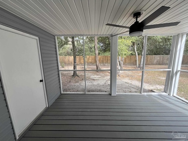 unfurnished sunroom with plenty of natural light, wood ceiling, and ceiling fan