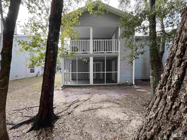 back of house with a balcony and a sunroom