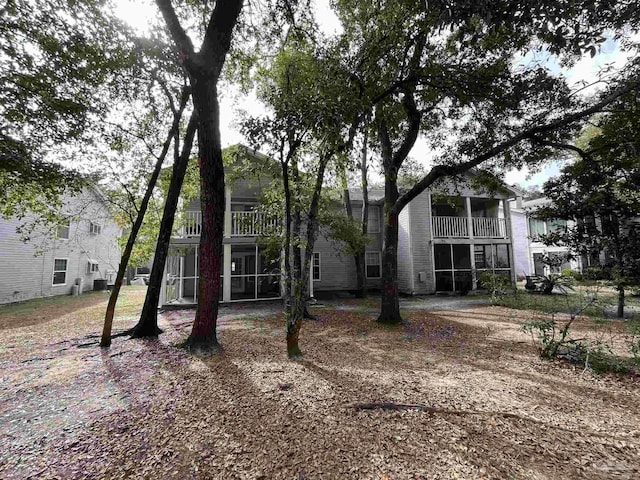 view of front of property with a balcony and a sunroom