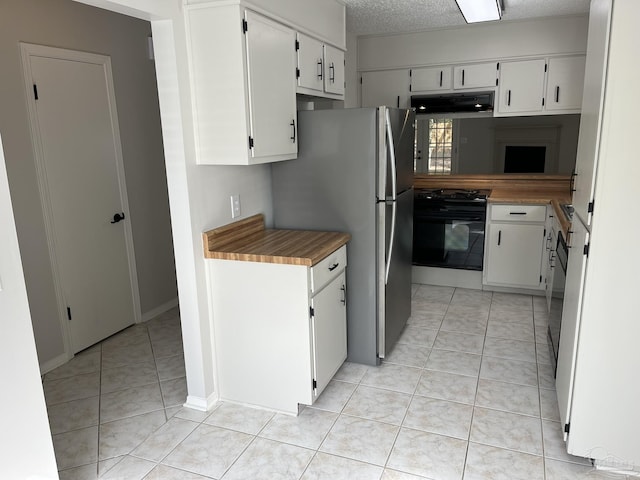 kitchen with black stove, light tile patterned floors, under cabinet range hood, and a textured ceiling