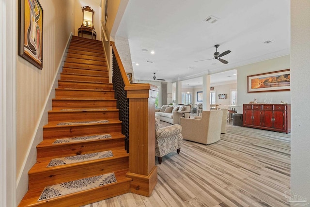 stairway featuring a ceiling fan, visible vents, wood finished floors, and recessed lighting