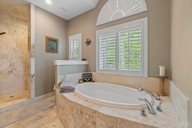 bathroom featuring a walk in shower, visible vents, and a bath