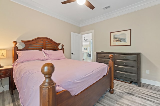 bedroom with visible vents, light wood-style flooring, ornamental molding, a ceiling fan, and baseboards