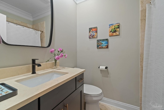 bathroom with curtained shower, toilet, vanity, baseboards, and crown molding