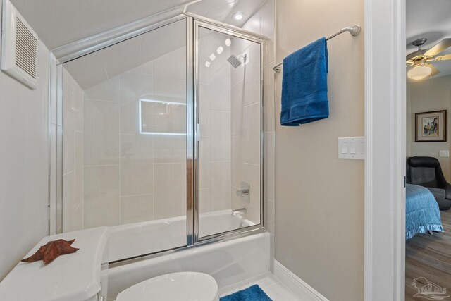 bathroom with connected bathroom, toilet, shower / bath combination with glass door, a ceiling fan, and baseboards