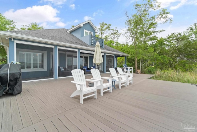 deck with a sunroom and grilling area