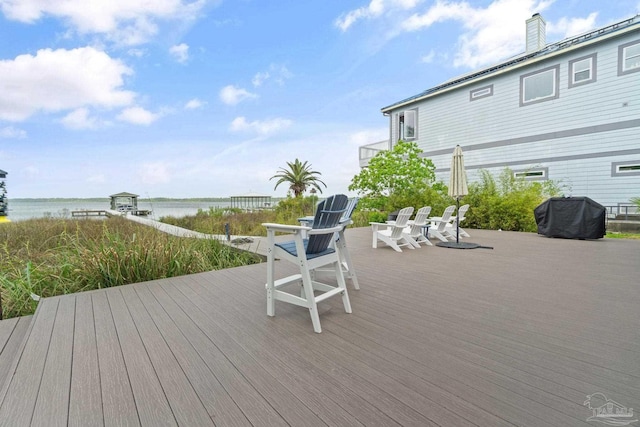 deck featuring a water view and area for grilling