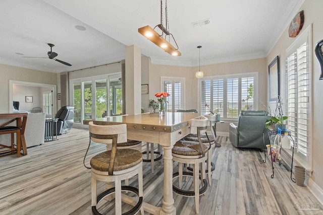 kitchen featuring open floor plan, visible vents, and crown molding