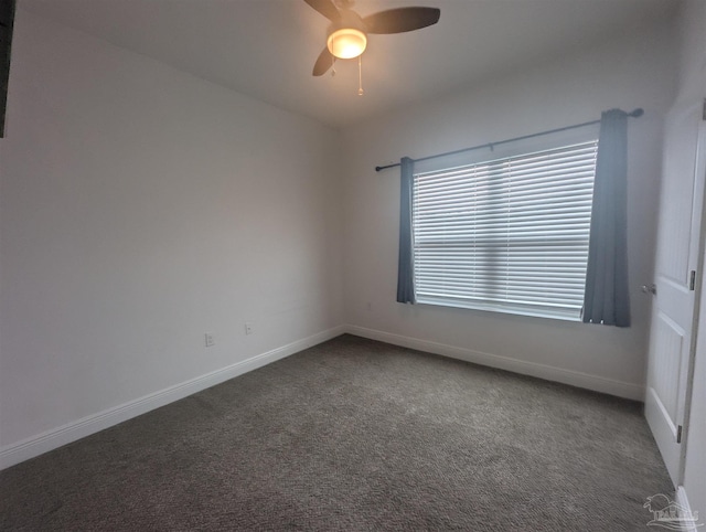 carpeted spare room featuring a ceiling fan and baseboards