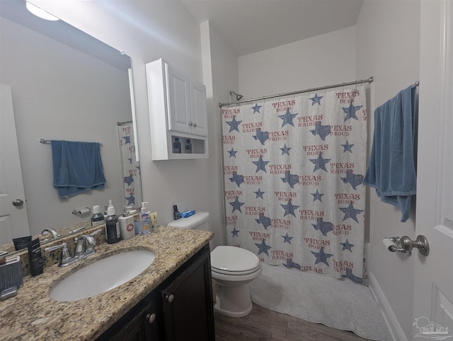 bathroom featuring a shower with shower curtain, vanity, toilet, and wood finished floors