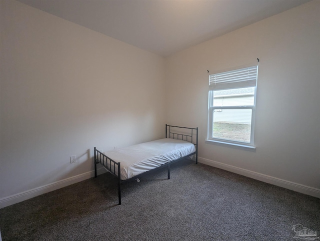 unfurnished bedroom featuring baseboards and carpet floors