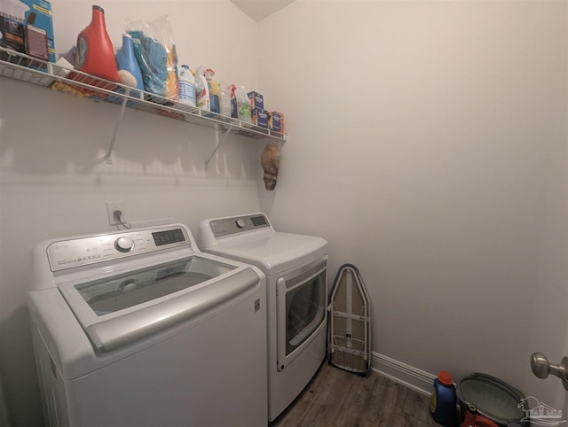 laundry room with dark wood-type flooring, laundry area, washer and clothes dryer, and baseboards