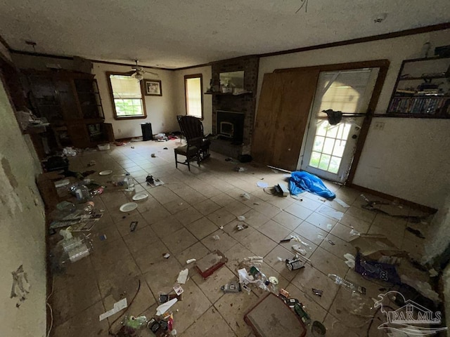 3010 N 6th Ave, Pensacola, FL 32503 - unfurnished living room featuring a textured ceiling, a fireplace, tile patterned flooring, and crown molding