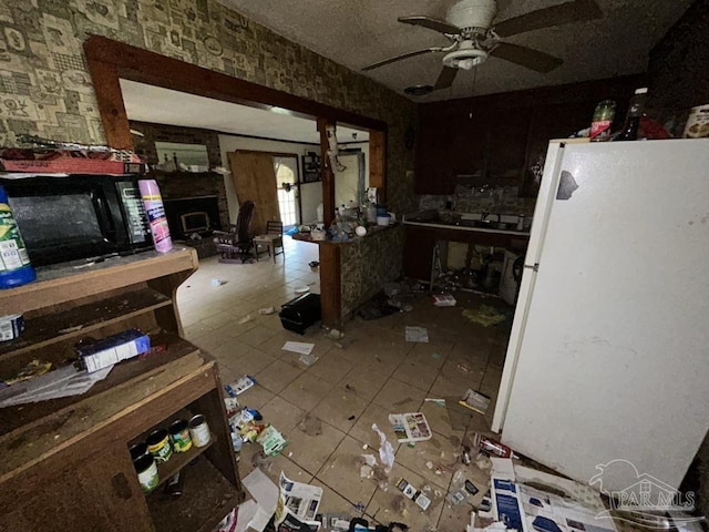 3010 N 6th Ave, Pensacola, FL 32503 - kitchen with freestanding refrigerator, black microwave, tile patterned flooring, and a ceiling fan