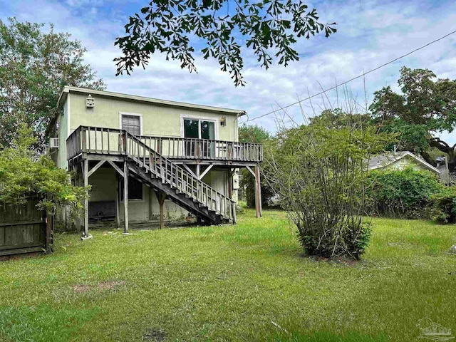 back of house with a lawn and a wooden deck