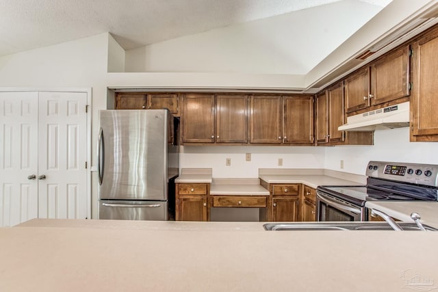 kitchen featuring lofted ceiling and stainless steel appliances