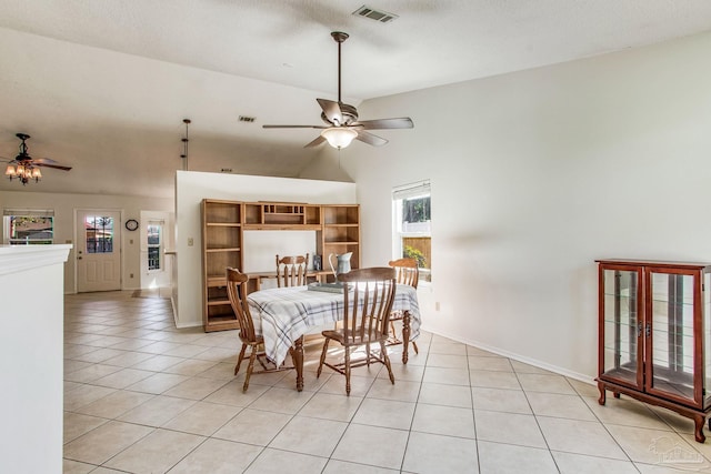 tiled dining area featuring vaulted ceiling, ceiling fan, and a textured ceiling