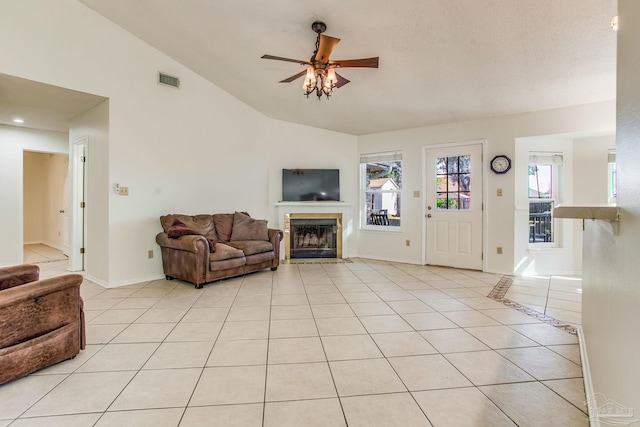 tiled living room featuring vaulted ceiling and ceiling fan