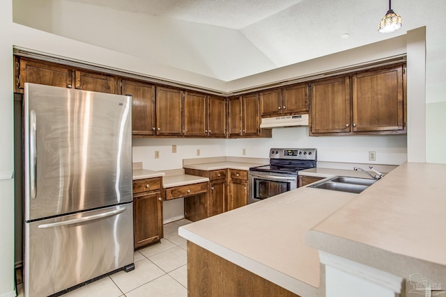 kitchen featuring vaulted ceiling, pendant lighting, kitchen peninsula, sink, and appliances with stainless steel finishes