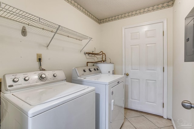 laundry area with water heater, light tile patterned floors, independent washer and dryer, a textured ceiling, and electric panel