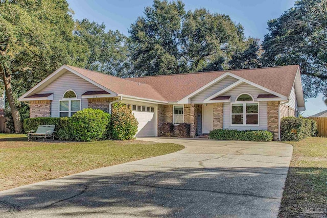 single story home featuring a front lawn and a garage