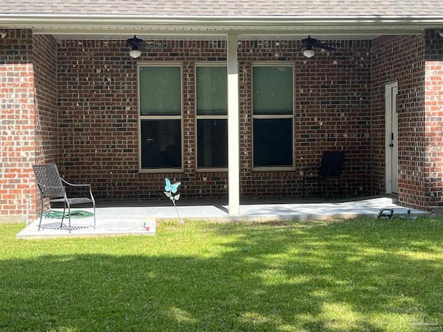 exterior space with a patio, ceiling fan, and a lawn