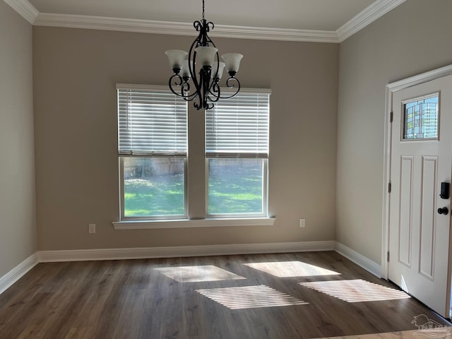 unfurnished dining area featuring ornamental molding, dark hardwood / wood-style floors, and a notable chandelier