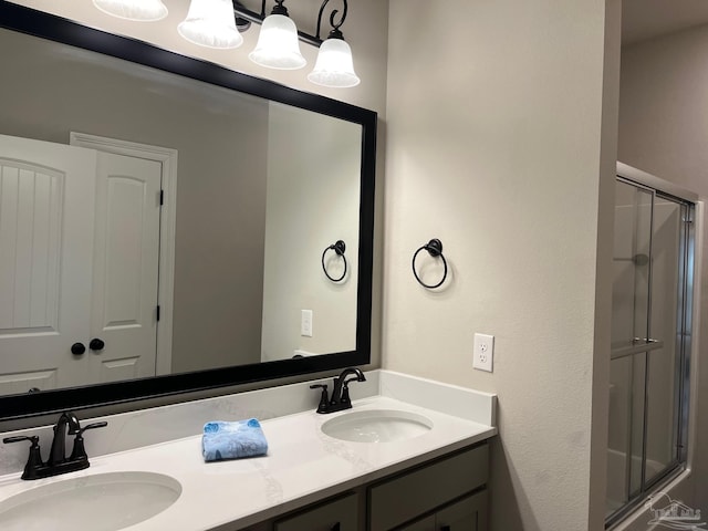 bathroom with vanity and a shower with shower door