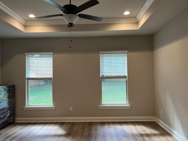 unfurnished room with ceiling fan, light wood-type flooring, ornamental molding, and a wealth of natural light