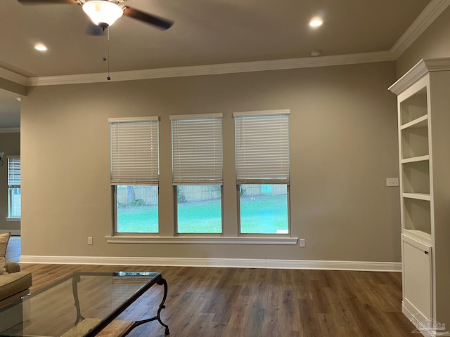 unfurnished room featuring dark hardwood / wood-style floors, a wealth of natural light, crown molding, and ceiling fan