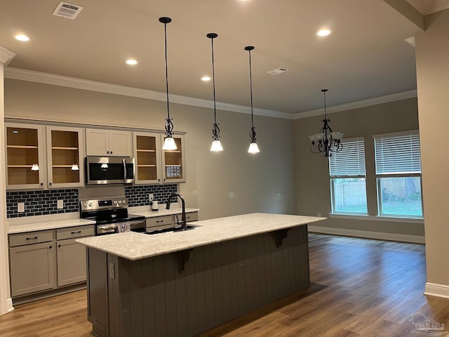 kitchen featuring pendant lighting, sink, gray cabinets, wood-type flooring, and stainless steel appliances