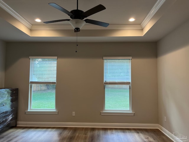 spare room with hardwood / wood-style flooring, crown molding, and a wealth of natural light