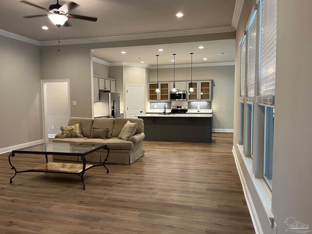 kitchen with gray cabinets, decorative backsplash, stainless steel fridge, and ornamental molding