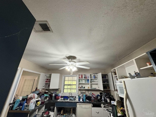 office space with a textured ceiling, ceiling fan, and sink