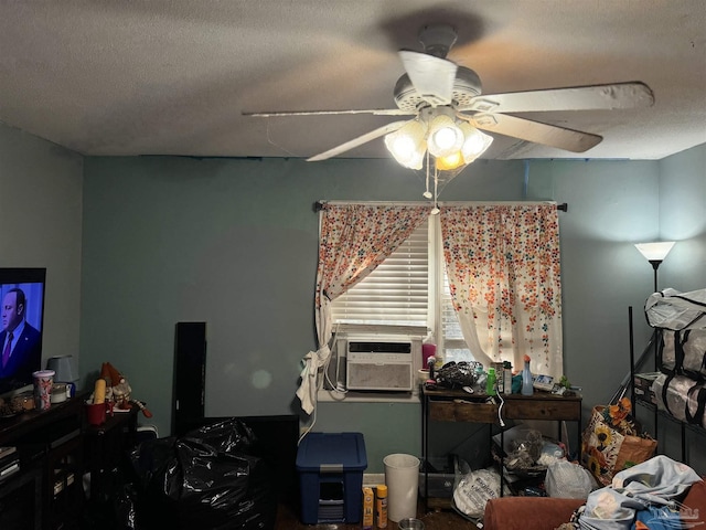 bedroom with a textured ceiling, ceiling fan, and cooling unit