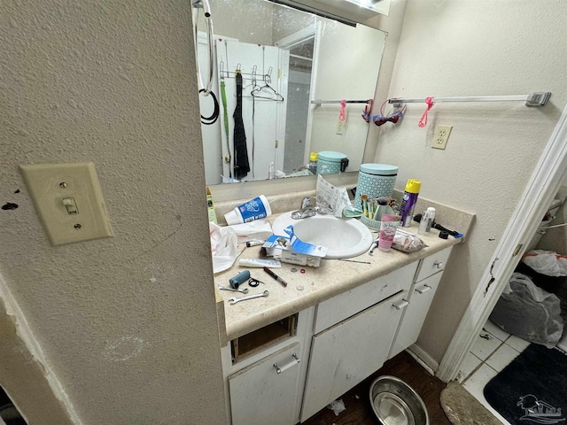 bathroom featuring tile patterned flooring and vanity