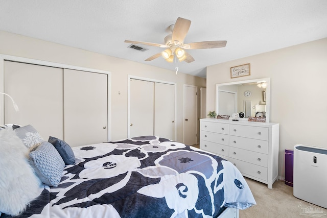 4701 Kitty Hawk Cir, Gulf Breeze, FL 32563 - bedroom featuring two closets, light colored carpet, refrigerator, and ceiling fan