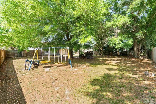 4701 Kitty Hawk Cir, Gulf Breeze, FL 32563 - fenced backyard with a playground